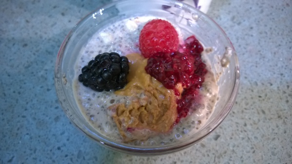 Chia Cups topped with berries, peanut butter and berry compote